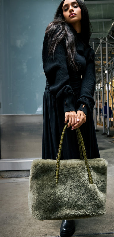 A woman carrying her Aimee Kestenberg Embrace Tote in kelp shearling.